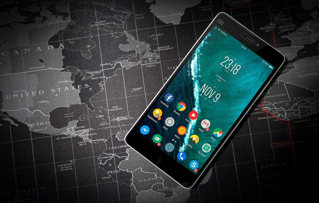 A smartphone superimposed on a world map